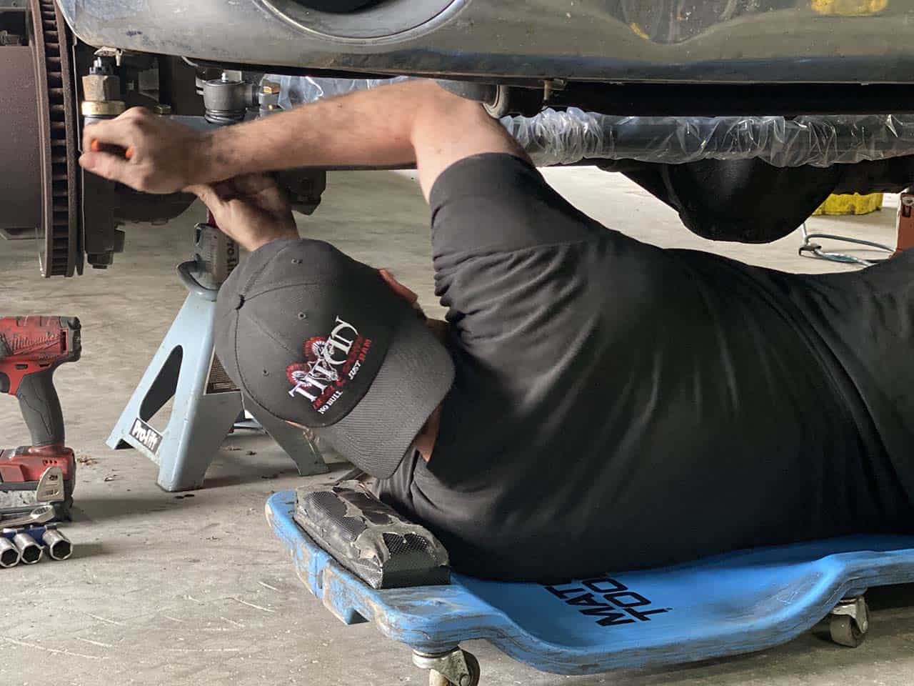 Titan Diesel Sports mechanic working on truck.